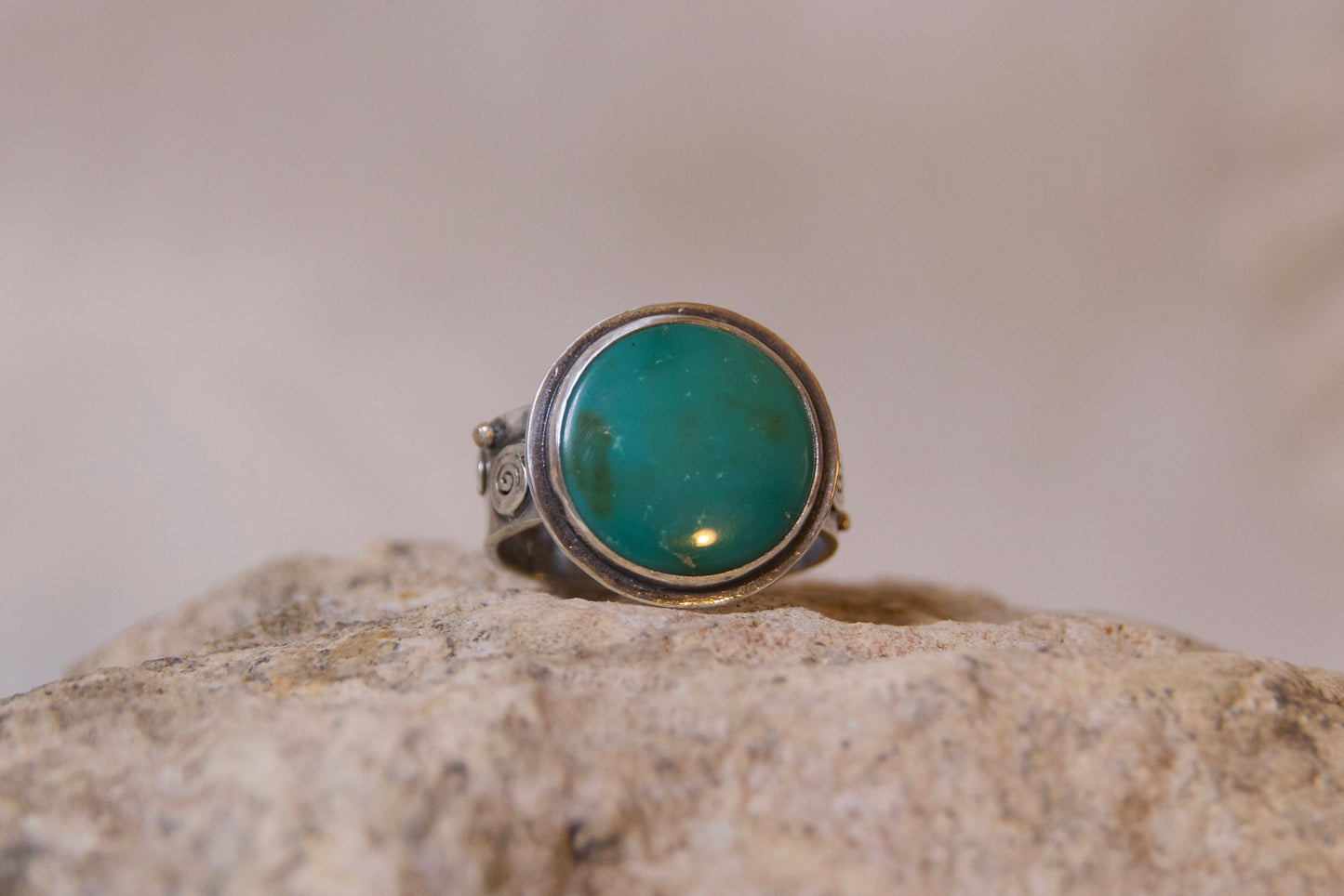 Turquoise stone set in sterling silver set on a rock