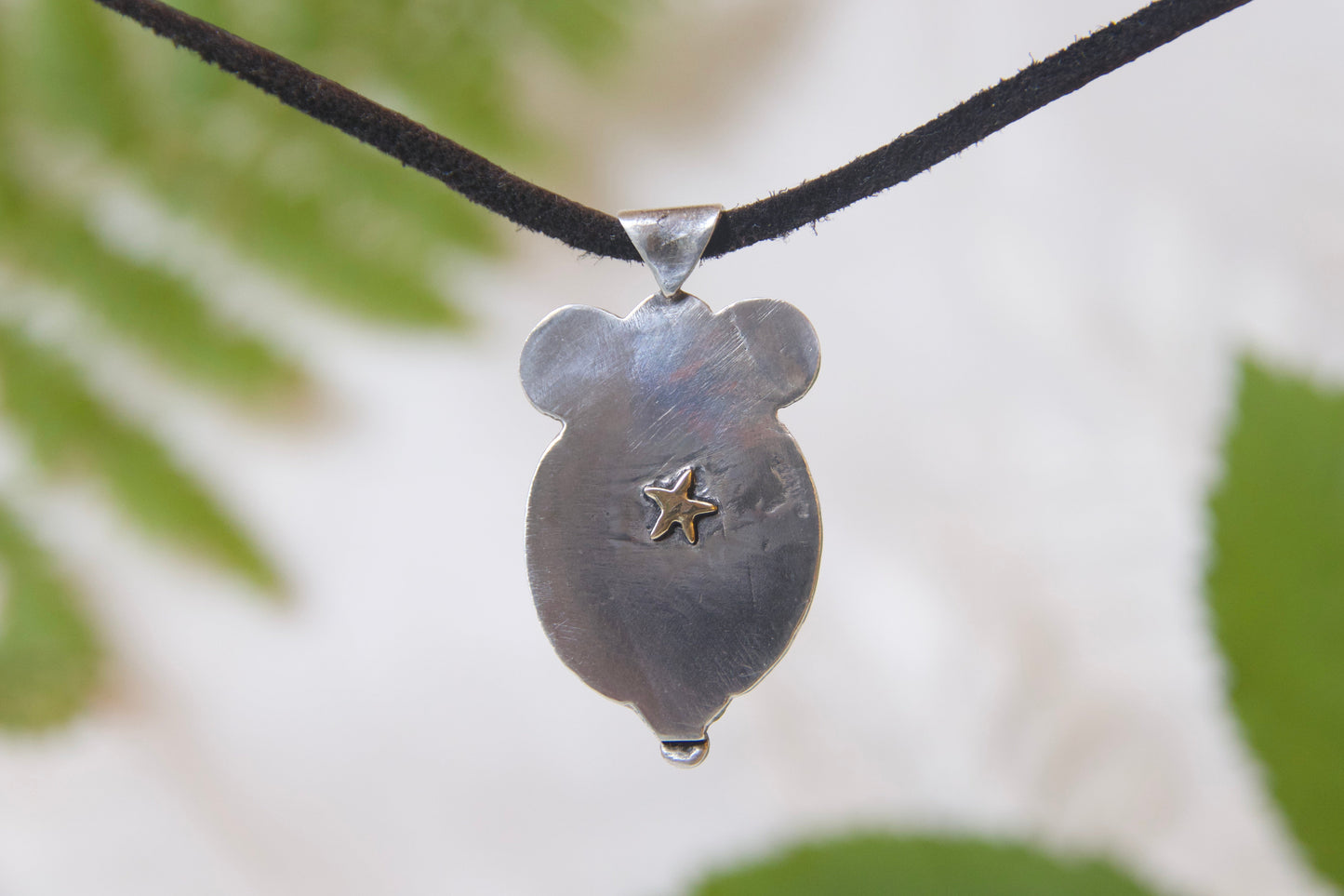 brass star on the back of sterling silver pendant 