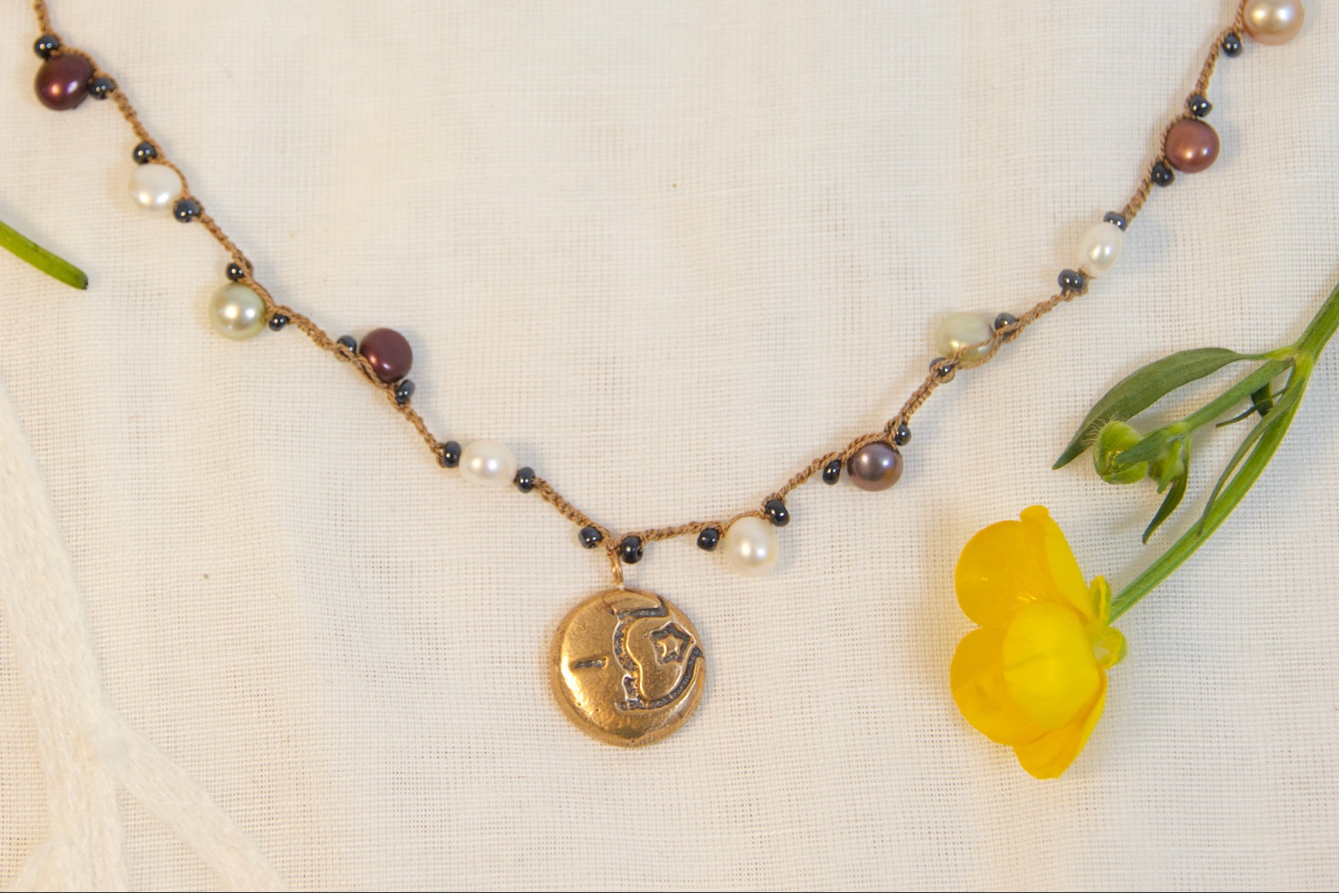 Necklace with yellow flowers on a textured surface