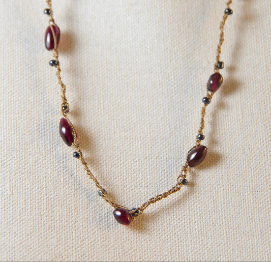 Necklace with brown beads on a beige fabric background