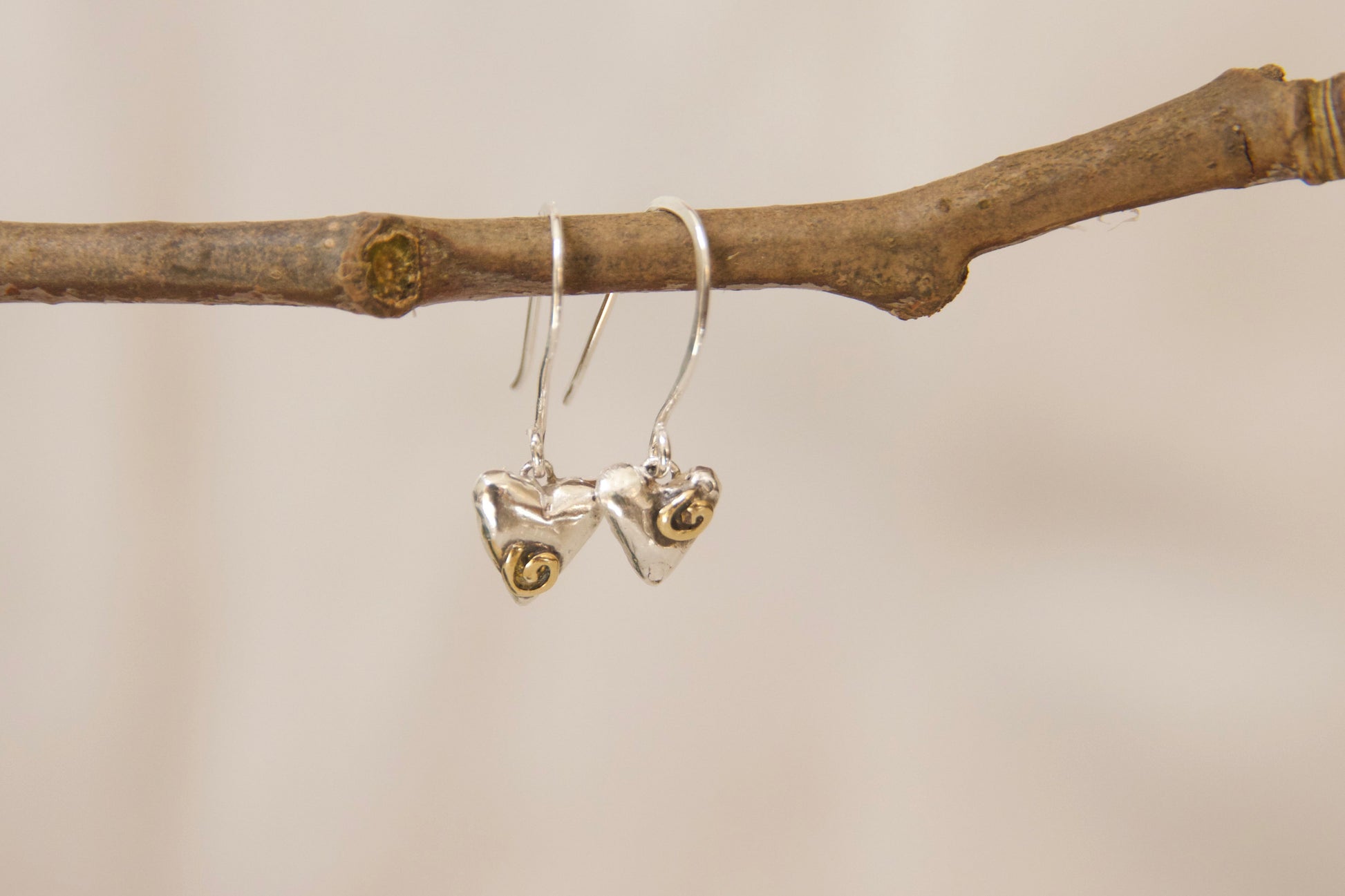 Unique whimsical one of a kind sterling silver and brass heart earrings. Small heart earrings with sterling silver hooks 