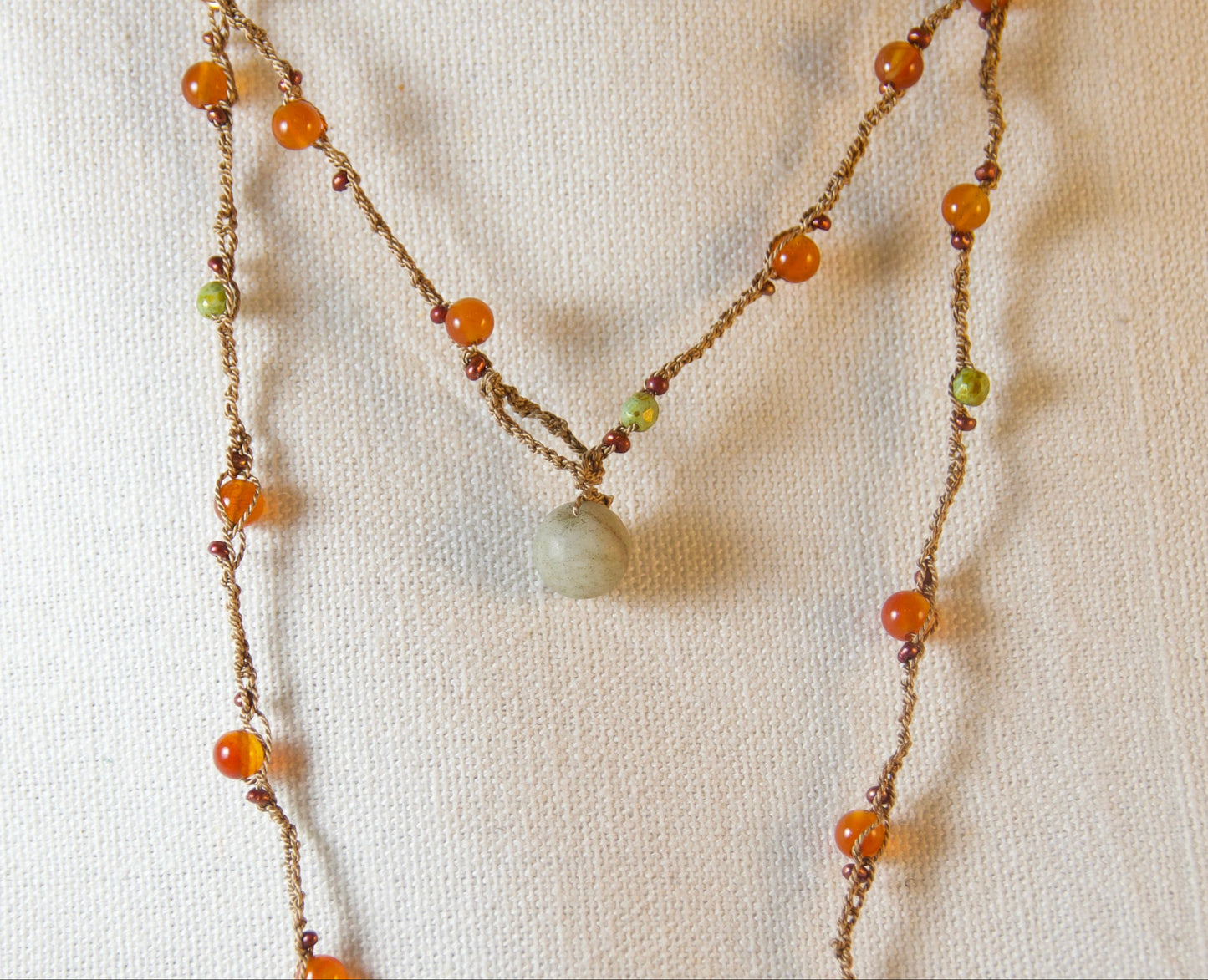 Beaded necklace on a textured white background