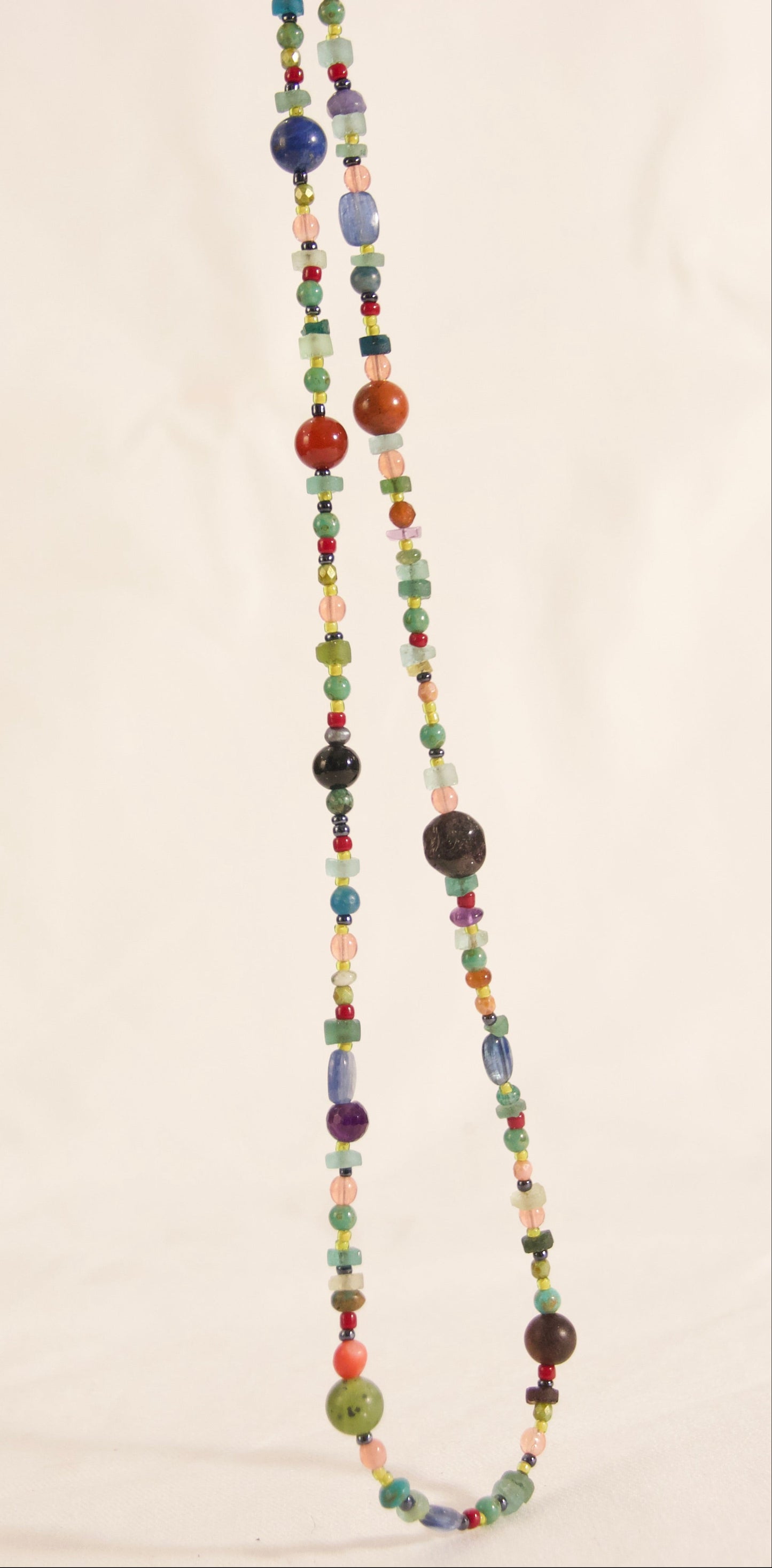 Multicolored beaded necklace on a plain background