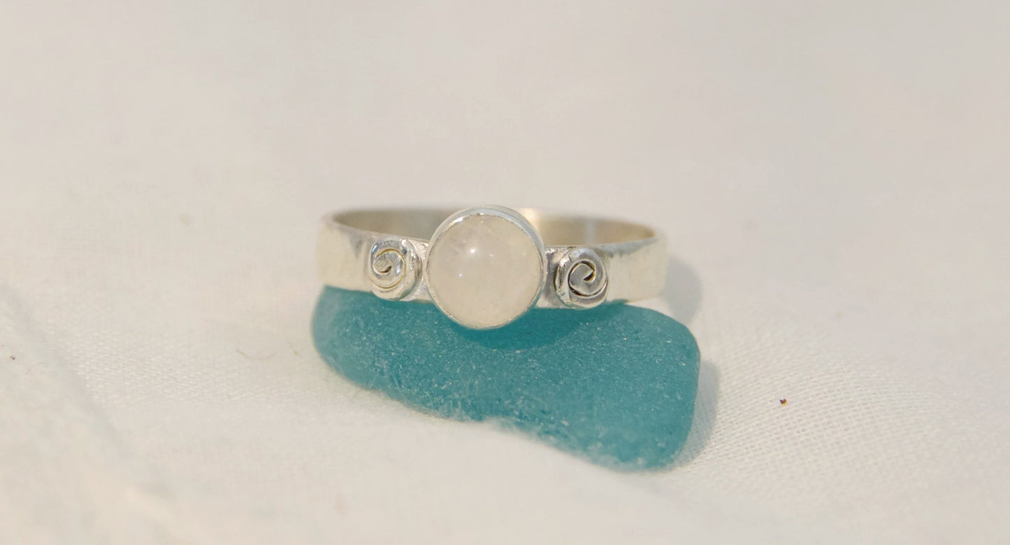 Moonstone center stone between two swirls 