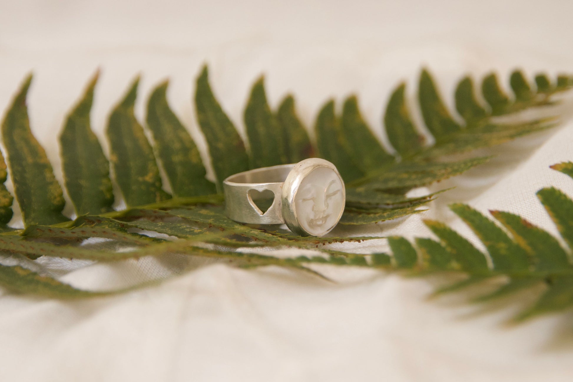 Kind pearl face on hand, beautifully crafted heart cutout on side