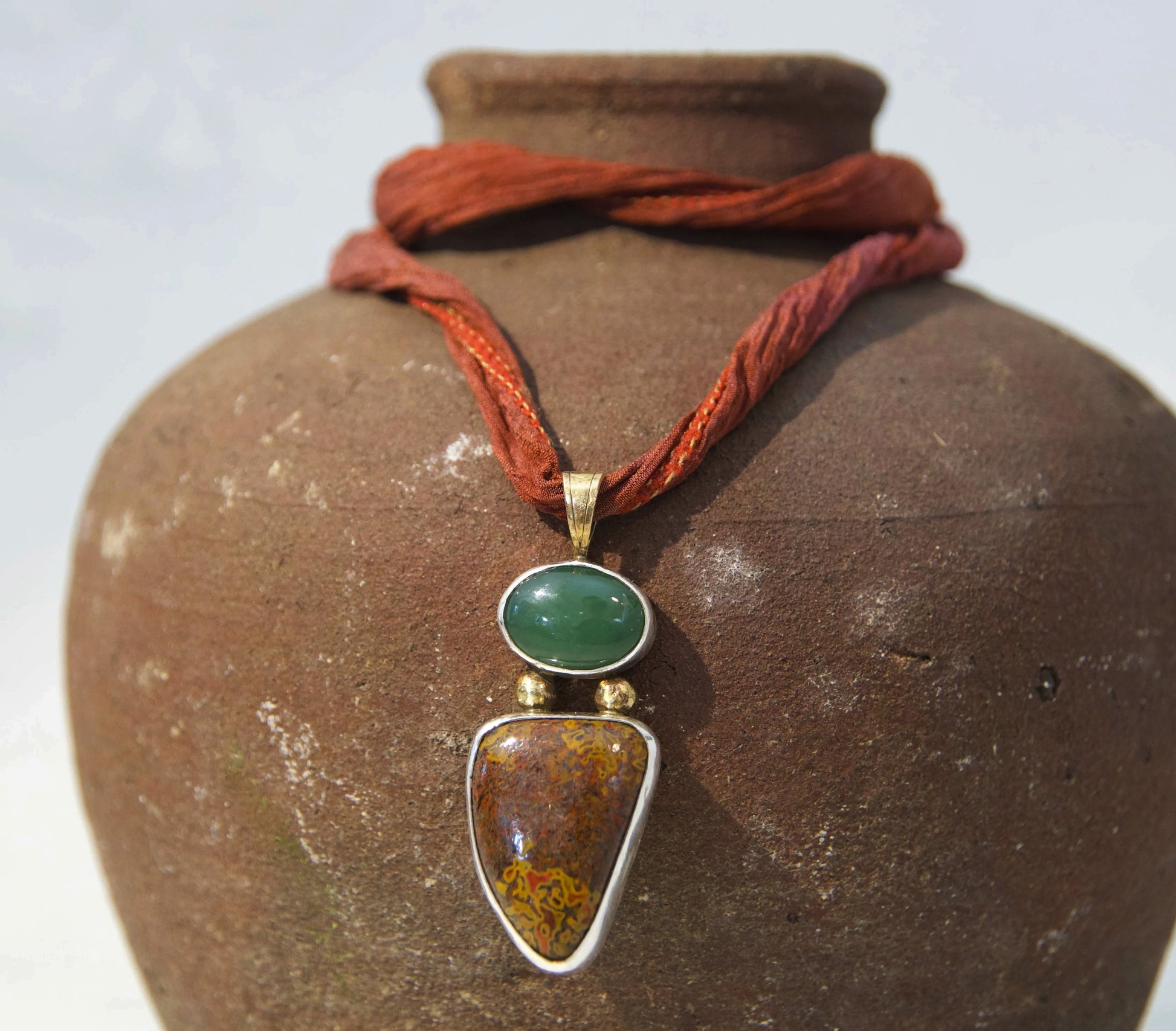 Hand made jasper and jade pendant using sterling silver and bronze on a handmade silk cord 