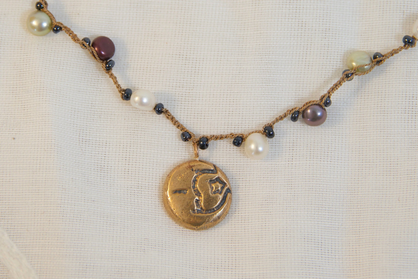 Necklace with beads and pearls on a light background