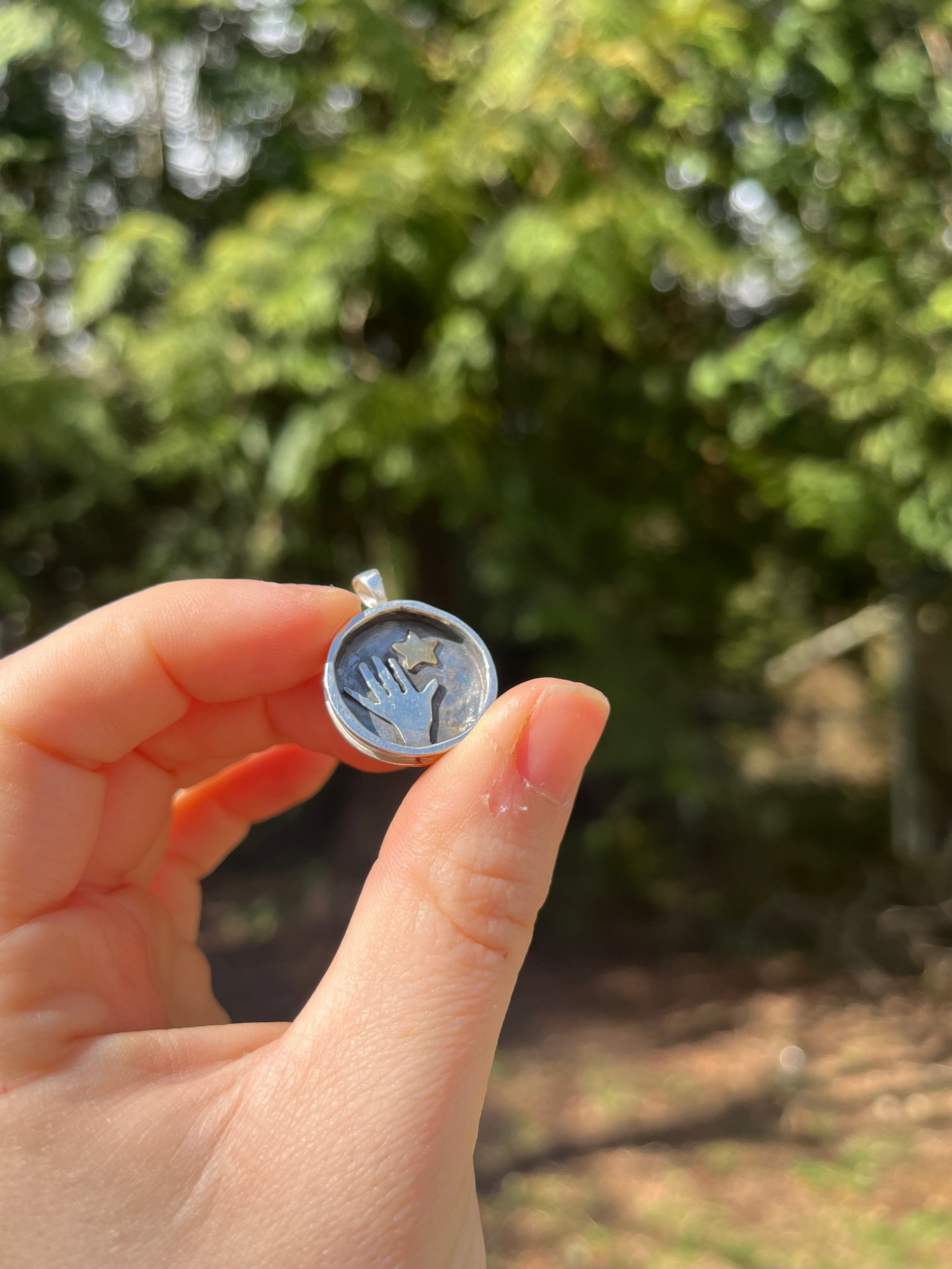 Whimsical hand and star pendant
