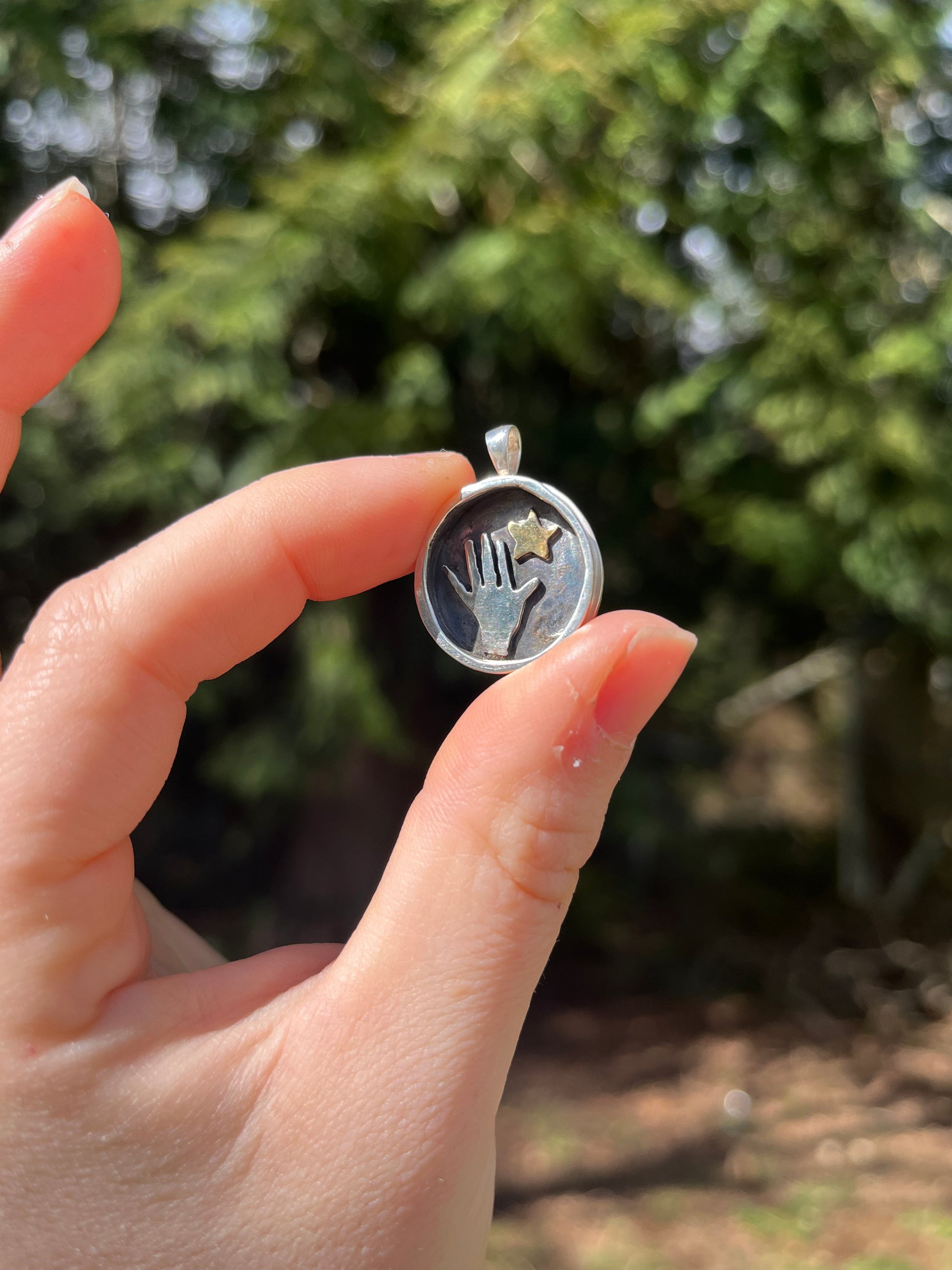 Handmade sterling silver pendant with whimsical star but out handmade silversmith pendant