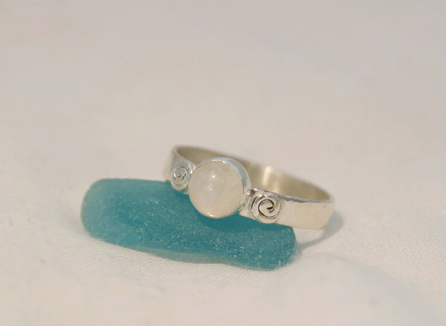 Silver moonstone ring with hand made swirls 