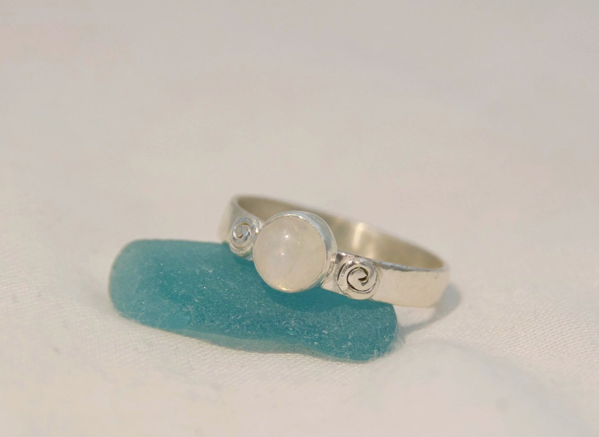 Silver moonstone ring with hand made swirls 
